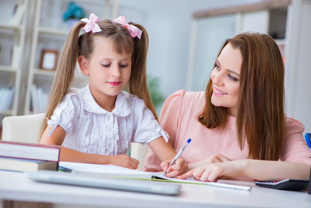 Nanny helping child with homework